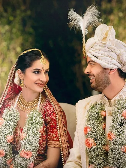 The look they share says everything. A candid moment of the bride and groom at their mandap, filled with love and admiration.