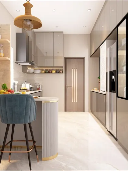 This modern kitchen features a long, sleek layout with glossy grey cabinets and a stylish breakfast bar with teal velvet stools. The design is perfect for open-plan living.