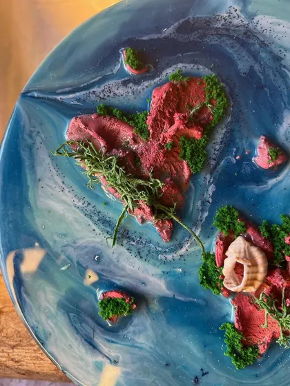 A custom resin piece featuring a heart-shaped island with a sprig of moss, symbolizing life and love. I can customize these islands to represent a special place or memory for you.