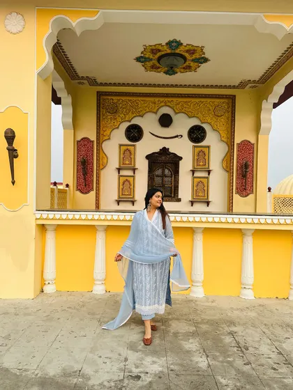 The flowy chiffon dupatta adds a touch of grace to this elegant blue and white ethnic suit.