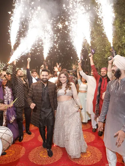 A grand entrance for the happy couple, surrounded by friends, dhol players, and cold pyros. I help plan and execute these high-energy moments.