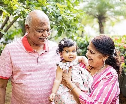 The pride and joy on grandparents' faces as they hold their grandchild. Including the whole family creates such precious memories for everyone to look back on.