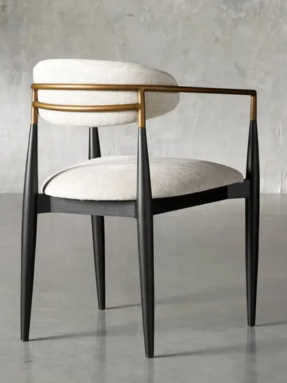 The Jagger dining armchair, with a continuous metal armrest that wraps around the back, adding to its sleek, modern aesthetic.