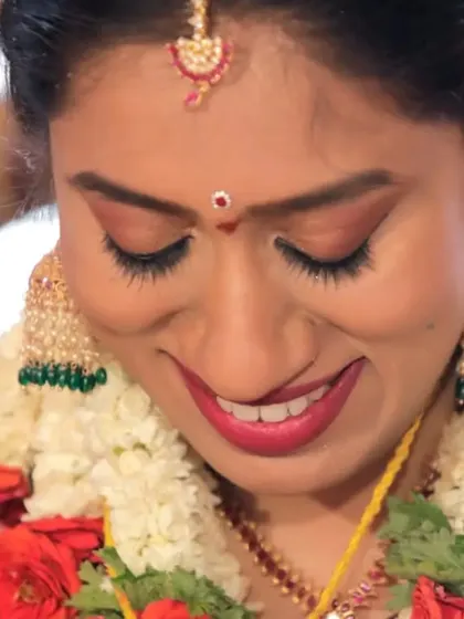 A close-up candid shot of the bride with a gentle, happy smile. These portraits capture the quiet moments of joy and contentment on the wedding day.