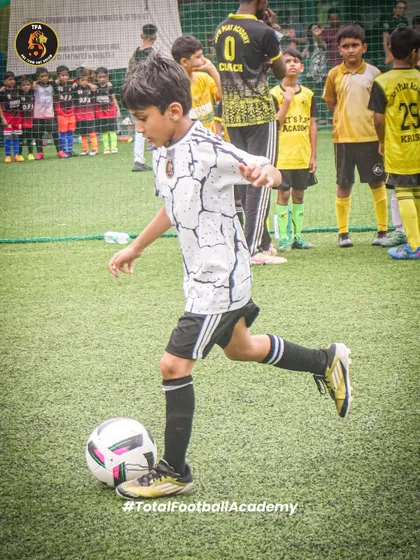 Every touch counts. A young player demonstrates precise ball control during a competitive match.