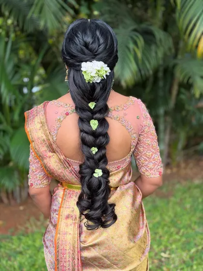 Another view of the minimalist floral braid, showing how the green leaves add a unique and natural touch to the hairstyle.
