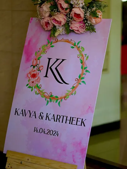 A custom welcome sign with a floral wreath monogram for Kavya and Kartheek's wedding.