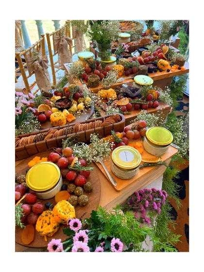 An example of how our decor extends to every aspect of the event, including food presentation. This lavish grazing table is adorned with fresh flowers and greenery, turning it into a feast for the eyes as well as the palate.