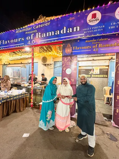 A happy family from the Bohra community posing with our team member. We value our connection with our guests.