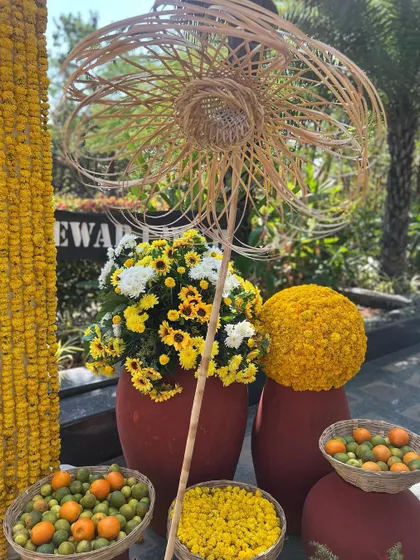 Details from a haldi celebration, featuring handmade cane umbrellas, terracotta pots, and baskets of fresh citrus and flowers.