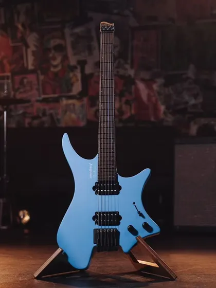 Another view of the light blue Strandberg guitar, highlighting its distinctive body shape and hardware.