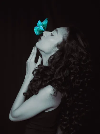 Another artistic shot from our creative series. The selective color of the butterfly against the monochrome portrait creates a striking visual contrast, highlighting the delicate makeup details.