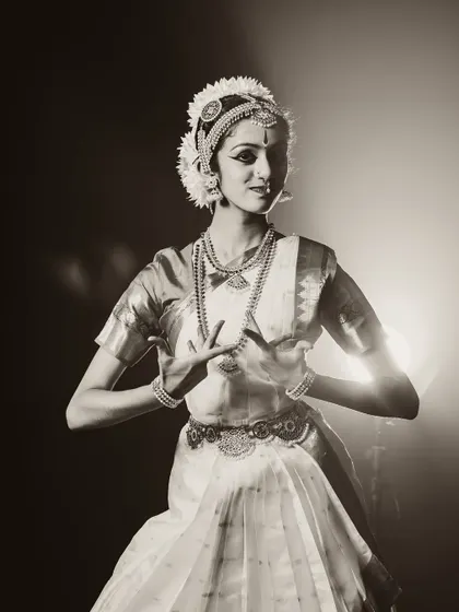 A beautiful portrait of a classical dancer. The sepia tone and soft backlighting create a nostalgic and timeless feel.