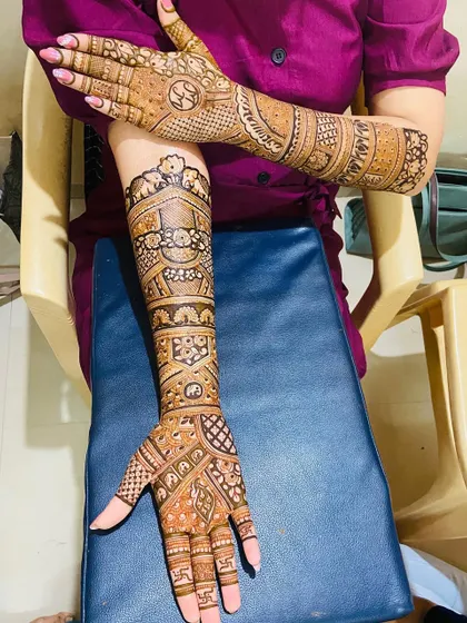 The full view of the bride's arms, covered in stunning, detailed henna work.