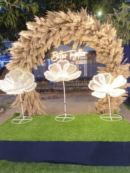 A beautiful photo point with a pampas grass arch and a 'Better Together' neon sign, perfect for capturing memories.