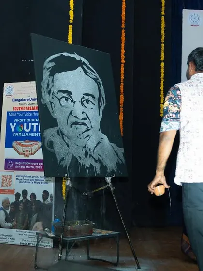 The completed portrait of the Bangalore University Vice-Chancellor, revealed after a fast-paced painting session. The final artwork stands as a testament to the event.