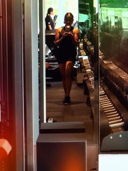 Another perspective of my workout. The rows of dumbbells in the background represent the endless possibilities for building strength.