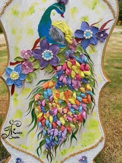 A detailed view of the peacock's body and its magnificent tail, where each feather is a tiny, colorful sculpture.