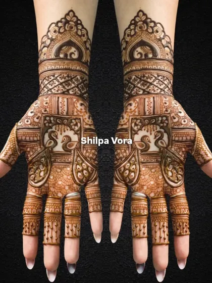 A symmetrical bridal design featuring peacocks in jharokhas and elephants on the wristband.