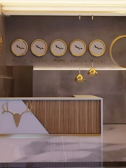 This modern reception area is a perfect example of our branded environment design. We created a custom desk that combines natural wood textures with a clean, white finish and integrates the company's logo. The feature wall with multiple time zone clocks adds a functional, global touch, ideal for a contemporary corporate office.