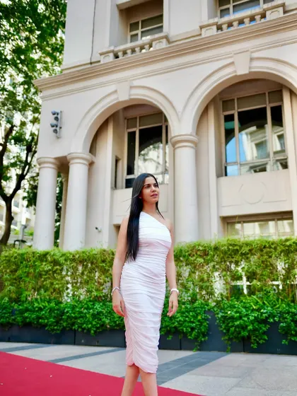 Walking the red carpet in a chic, one-shoulder white dress. This look is all about confidence and modern elegance.