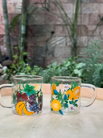 These upcycled cups feature a mix of grapes and bananas, turning simple glassware into a cheerful, artistic set.
