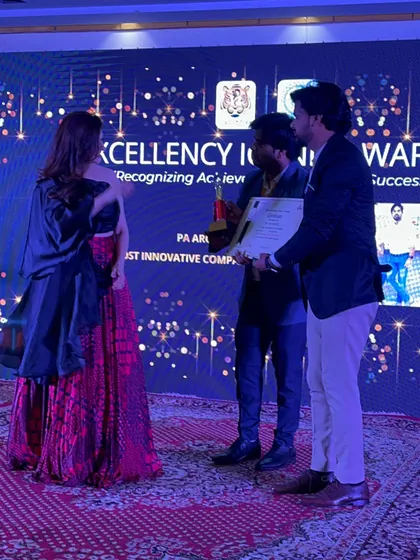 Receiving the certificate and trophy for the Excellency Iconic Award on stage.