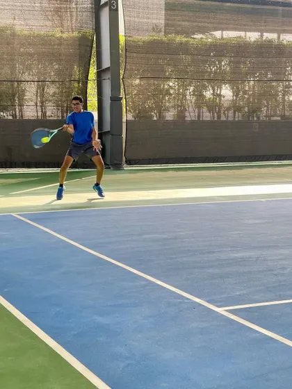 A junior player lunges for a forehand, showing the agility and determination fostered in our young athletes.