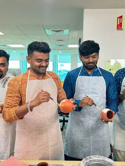 Team members working together and sharing a creative moment. These are the kinds of interactions that build stronger workplace relationships.