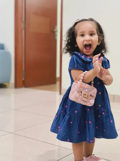 My daughter's excited expression in her Firstcry summer dress. Finding clothes that she loves to wear makes getting ready so much more fun.