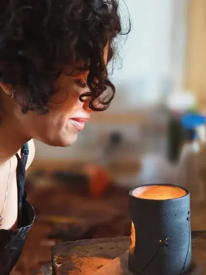 The student smiles as she admires her finished candle holder, the light flickering inside. The satisfaction of creating something both beautiful and functional is immense.