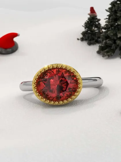 A fiery masterpiece to ignite your holiday elegance. This custom ring features a brilliant red gemstone in a textured gold bezel setting on a simple white gold band, a modern design with a classic feel.
