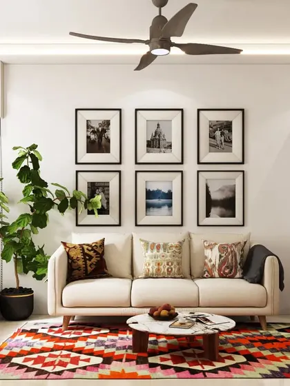 This living room combines a neutral sofa with a colorful geometric rug and a wooden swing, creating a playful and inviting atmosphere. The gallery wall of black-and-white photos adds a personal touch.