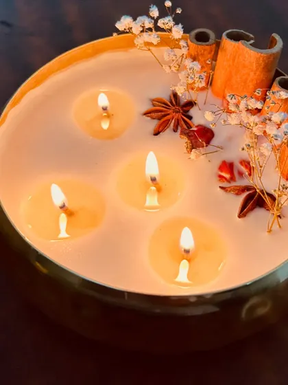 This is one of my favorite creations, a premium 6-inch metal urli candle. I've adorned it with real dried flowers and spices like cinnamon and star anise. It creates such a warm, luxurious glow and is perfect for making any space feel special, especially during festivals.