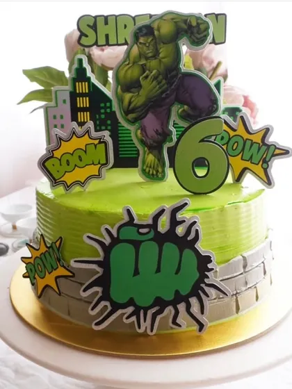Hulk smash. This superhero cake set includes a large Hulk topper and smaller "Boom!" and "Pow!" cutouts to decorate the cake, creating an action-packed scene.
