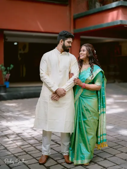 A classic portrait of Nidhi and Aditya, their colorful traditional outfits complementing each other perfectly.