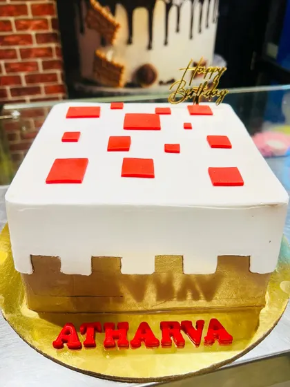 A minimalist yet instantly recognizable Minecraft cake block. This square cake is designed to look like a piece of the game's terrain, making it a cool and modern choice for a fan's birthday.