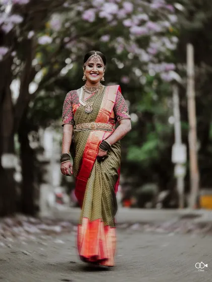 A beautiful portrait of the bride walking down a path strewn with flowers, her smile radiant.