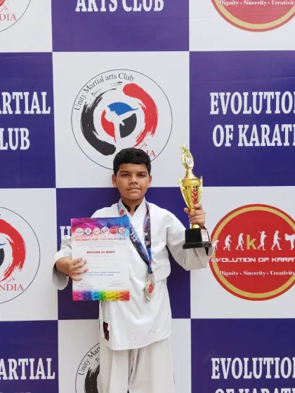 One of our dedicated students posing with his certificate, medal, and trophy after a win at the South Indian Open Karate Championship 2025.