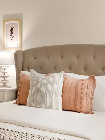 This is the second bedroom from the JWD Marq Home. I mixed design styles, pairing a classic tufted wingback headboard with modern lamps and layered textiles in soft blush tones to create a room that feels both elegant and comfortable.