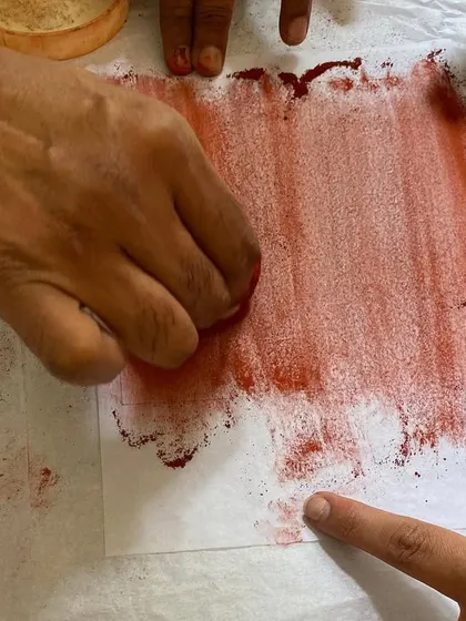 Wiping ink from a plate, a crucial step that determines the tonal quality of the final print. It is a subtle art that requires a sensitive touch and a keen eye.