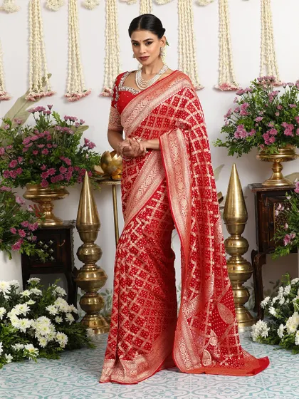 The full view of the red Banarasi Bandhani saree, a timeless and elegant choice for a bride or wedding guest.