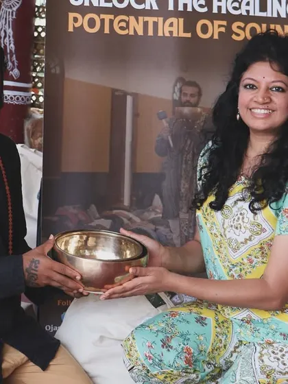 Sharing knowledge is a gift. Here, I am presenting a singing bowl to a student, marking the beginning of her journey as a sound healer.