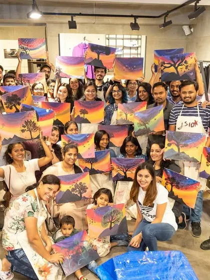 The whole crew from the Adidas workshop posing with their incredible sunset paintings. It was a full house and a night of unforgettable creative vibes.