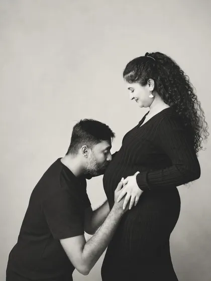 Sometimes, the most powerful images are the simplest. This black and white portrait focuses on the quiet, intimate connection between a father and his unborn child, a moment of pure anticipation and love.