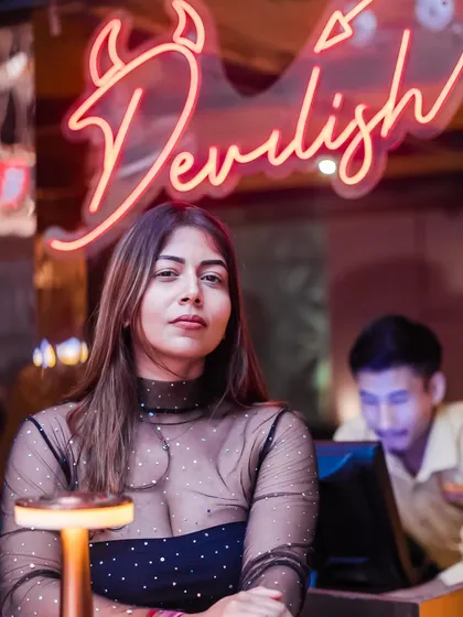 The neon 'Devilish' sign adds to the cool, edgy decor of the venue.
