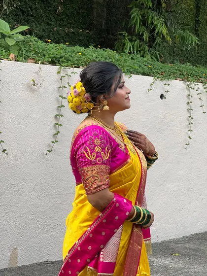 A side profile of my bride Krutika, showing off her beautiful floral bun made with yellow flowers.