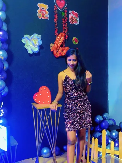 A stylish pose from a birthday girl, with our blue-themed decor and a heart-shaped prop.