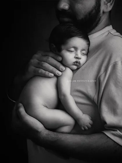 The black and white version of a newborn sleeping on their father's chest. This treatment enhances the texture and emotion of this incredibly tender moment.