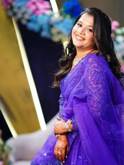 A beautiful look for a wedding guest in a vibrant purple saree. The makeup is kept fresh and glowy to balance the bold color.
